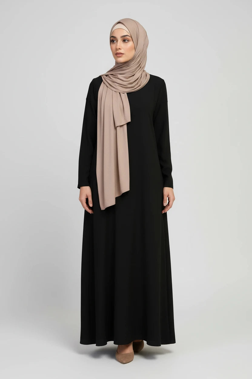 A woman modeling a draped taupe-beige hijab scarf, with additional color options displayed on mannequins and as circular swatches. The image shows the scarf in teal, mustard, black, and light taupe, along with smaller model views at the bottom.